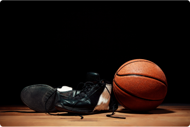 Basketball and shoes on a wooden floor